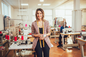 Portrait of happy dressmaker woman in studio.