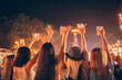© minastefanovic - Back view of female friends drinking beer and dancing at music festival
