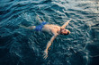 © Westend61 - Young man floating on water