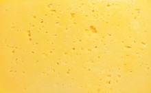 Cheese Texture. Background Of Fresh Yellow Cheese With Holes