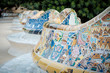 Details of a colorful ceramic bench at Parc Guell designed by Antoni Gaudi, Barcelona, Spain.