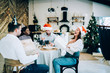 © GalakticDreamer - Group of delighted Christmas friends laughing and giving presents