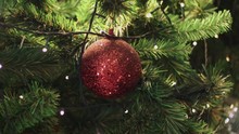 4k Close Up, Red Glitter Sphere Hanging On Christmas Tree, Night Before X'mas Theme, Santa Claus, Dark Low Light, Movement To The Left Shot, Holidays Decorating, Twinkle Light, Red Green Gold Yellow