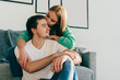 © GalakticDreamer - Couple cuddling on couch with tenderness at home