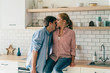 © GalakticDreamer - Happy young couple embracing in kitchen