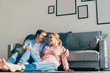 © GalakticDreamer - Happy couple embracing on floor in living room