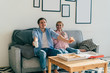 © GalakticDreamer - Cheerful couple eating pizza on couch