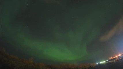 aurora borealis in the night northern sky. ionization of air particles in the upper atmosphere.