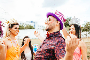 Wall Mural - Brazilian Carnival. Group of Brazilian people in costume celebrating the carnival party in the city