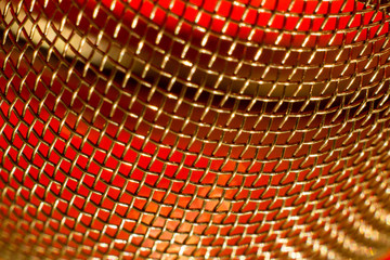 Macrophotography of a metal strainer with red background