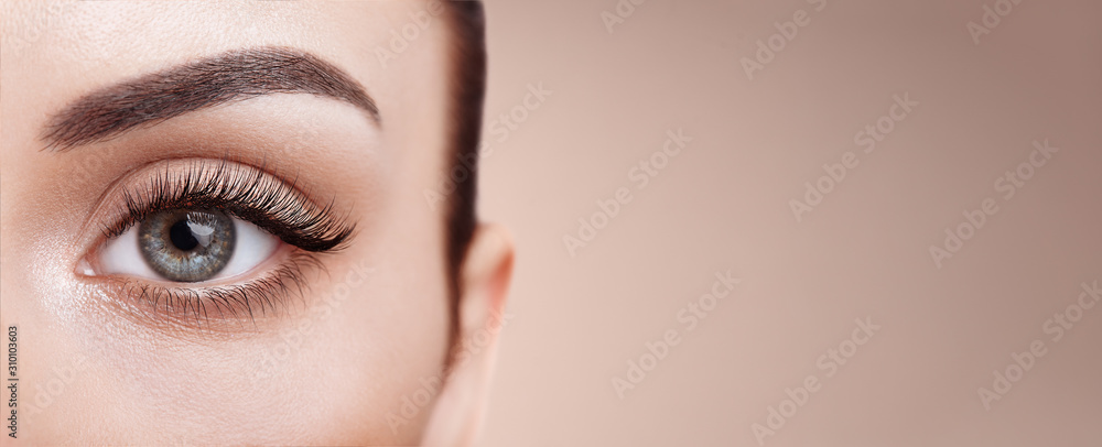 Female Eye with Extreme Long False Eyelashes. Eyelash Extensions. Makeup, Cosmetics, Beauty. Close up, Macro	 - obrazy, fototapety, plakaty 