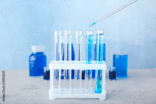Dripping of color sample into test tube in laboratory