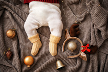 Cute Little Baby With Christmas Decor Lying On Plaid, Top View