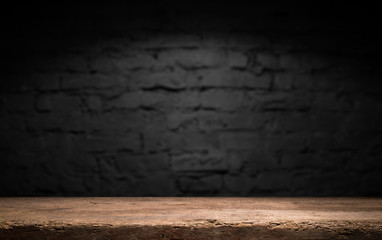 Wood table in front of rustic brick wall blur background with empty copy space on the table for product display mockup. Retro design montage presentation.