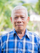 © meeboonstudio - Senior man wears a blue shirt stand in garden