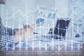 Multi exposure of financial graph with man works in office on background. Concept of analysis.