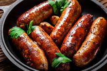 The Concept Of Farm, Organic Products. Homemade Grilled Pork Barbecue Sausages In An Iron Pan. Background Image. Copy Space