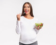 © Prostock-studio - Happy Pregnant Woman Eating Vegetable Salad, Studio Shot