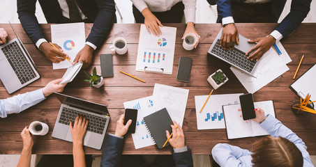 meeting of business team working with gadgets and documents