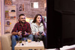 © DC Studio - Relaxed couple playing video games on television