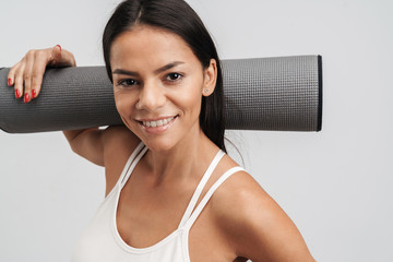 Canvas Print - Image of woman in sportswear holding fitness mat while doing workout