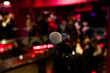 © Eva - microphone on a stand up comedy stage with colorful bokeh , high contrast image.