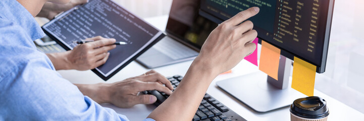 Pensive programmer working on on desktop pc programming code technologies or website design at office Software Development Company