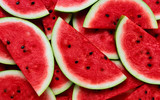 A large number of cut slices of watermelon