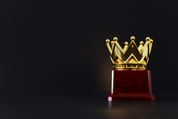 Wall Mural - image of golden crown award over wooden table.