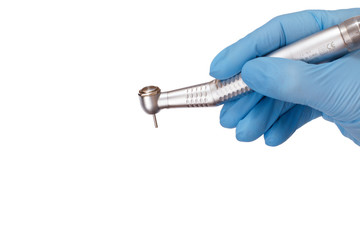 Dentist's hand in glove with dental handpiece.