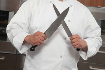 Wall Mural - Chef Sharpening Knives In Commercial Kitchen