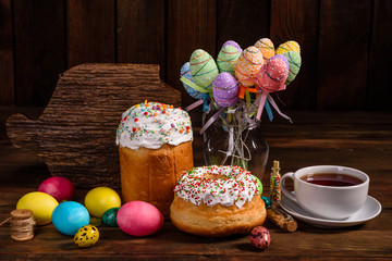 Easter cake and colorful eggs on a dark background