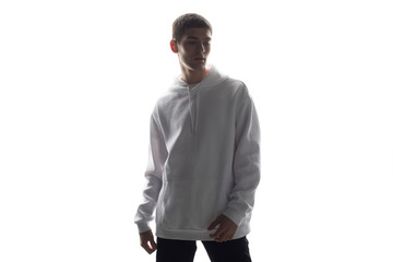 Wall Mural - Young man in a white hoodie sweater on white background. Mock-up.