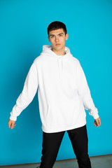 Wall Mural - Young man in a white hoodie. Mock-up.