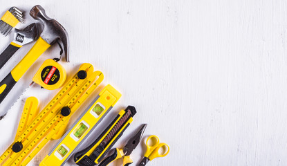 Set of yellow construction tools on white background