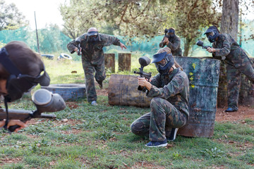 Wall Mural - Female paintball player aiming in shootout