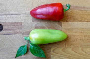 red and green bell pepper on a wooden cutting board