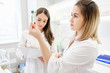 © Rithor - Two young pretty lab workers women examine record test data to create new effective anti-aging treatment. Technology Innovation Concept. DNA analysis Determination of paternity or family relationship
