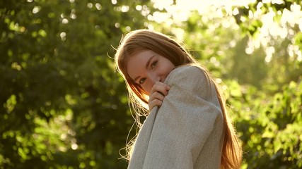 Poster - Beautiful young woman in park on sunny day. Slow motion effect