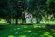 canvas print picture - Park with green fields and trees at day time