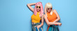 Leinwandbild Motiv Two Young carefree Woman in stylish sunglasses, striped pants. Beautiful fashionable model girl in trendy summer outfit. Graceful friends with fashion dyed hairstyle, make up on blue. Creative banner