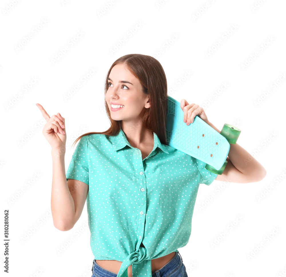 Stylish hipster girl with skateboard showing something on white background