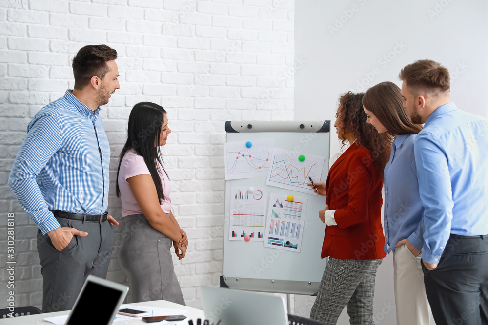 Colleagues discussing issue at business meeting in office