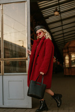 Outdoor Full-length Fashion Portrait Of Young Confident Elegant Woman Wearing Trendy Red Faux Fur Coat, Sunglasses, Beret, Lace Up Ankle Boots, Holding Leather Bag, Handbag, Posing In Street Of City