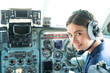 Happy and successful flight. Smiling female pilot in the aircraft , she is holding aviator headset and looking at camera. Wishes a successful fligh.
