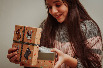 Teenage girl holding Christmas gift