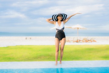 Portrait beautiful young asian women happy smile relax around swimming pool