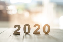 2020 Text With Wood Cut On Wooden Floor On Pastel Bokeh In Happy New Year 2020 Concept