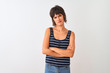 © Krakenimages.com - Young beautiful woman wearing striped t-shirt standing over isolated white background skeptic and nervous, disapproving expression on face with crossed arms. Negative person.