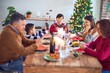 © Krakenimages.com - Beautiful family smiling happy and confident. Eating roasted turkey using smartphone celebrating christmas at home
